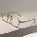 Détail d'une monture de lunettes ronde champagne avec double pont métallique rétro - Monture Vert Jelly Verres Transparents
