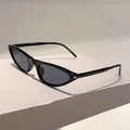 Detail view of small triangle cat-eye sunglasses with black frame and gold hinge accents - Black Frame Grey Lens
