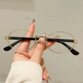 Chic oval sunglasses with golden metal frames and black temples for a retro look - Gold Frame Clear Lens