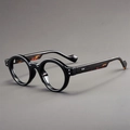 Detail of round black glasses frame with silver stud accents and tortoiseshell temples - Black Frame Clear Lens Tortoise Legs