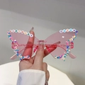 Pink butterfly party sunglasses featuring Birthday Queen bead letters and candy sprinkles - Pink