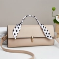 Detail of beige faux leather crossbody bag with polka dot scarf and gold twist lock - Khaki