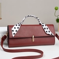 Reddish brown pebbled leather crossbody bag with polka dot scarf handle and gold lock - Red