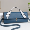 Blue lychee leather shoulder bag with gold twist lock and a polka dot scarf handle - Blue