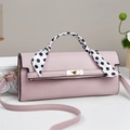 Pink leather handbag with golden lock and polka dot scarf handle on marble surface - Pink