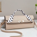 Elegant beige leather crossbody bag with silk scarf wrapped handle in a 45-degree side view - Khaki