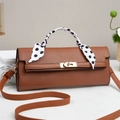 Detail of brown litchi texture handbag with polka dot scarf handle and gold twist lock - Khaki/Earth Yellow