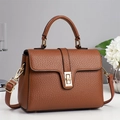 Detail of brown litchi texture leather handbag with golden rotating lock and top handle - Khaki/Earth Yellow