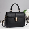 Minimalist black lychee leather crossbody bag with gold turn-lock and top handle - Black
