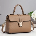 Detail view of tan crossbody bag with lychee grain texture and golden twist lock - Khaki