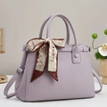 Close-up of lavender leather handbag with litchi texture and elegant silk scarf detail - 30x21x12cm / Purple