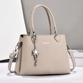 Elegant beige lychee texture leather handbag for women with floral pendant and strap - Light Khaki