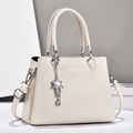 Elegant beige lychee grain leather tote bag with silver chain flower pendant and handles - Off White