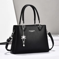 Elegant black pebble leather handbag with silver lettering and top handles for women - Black