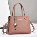 Chic lotus pink leather tote bag with large capacity and detachable strap on white stand - Pink