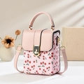 Pink mini square bag with cherry print and golden hardware on a minimalist background - Pink