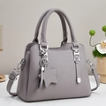 Minimalist grey textured leather handbag with detachable strap and star charm accessory - Gray