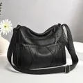Classic black leather crossbody bag with multiple zippers and textured litchi pattern - Black