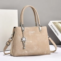 Elegant beige leather tote bag with silver floral charm and adjustable shoulder strap - Light Khaki