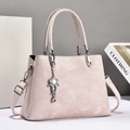 Elegant light pink leather tote bag with silver flower charm and adjustable strap - Pink