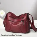 Burgundy multi-pocket soft leather crossbody bag with decorative cross stitching - Angola Red