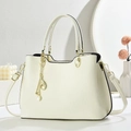 Detail of off-white lychee texture leather handbag with gold pearl charms and strap - Off-white