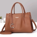Detail view of brown pebbled leather tote with C-pendant and removable shoulder strap - Khaki/Earth Yellow