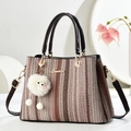 Brown woven tote bag with dark handles and a playful white plush monster charm - Coffee