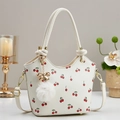 White cherry print crossbody bucket bag with fur ball and gold bow hardware - Off-white