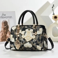 Vintage-style black handbag with elegant floral embroidery and pearl leaf charm detail - Black
