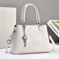 Minimalist white leather tote bag with silver flower charm and adjustable shoulder strap - Off-white