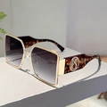 Close-up of tortoise shell square sunglasses with gold accents and gradient lenses - Gold Frame Gradient Grey Lens