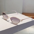 Detailed close-up of golden metal cat-eye sunglasses with purple gradient lenses and nose pads - Gold Frame Grey to Tea Gradient Lens