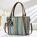 Striped woven tote bag with leather handles and decorative scarf on white background - Blue