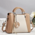 Detail of contrast stitching, woven handles and textured fabric on chic crossbody bag - Khaki
