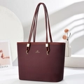 Detailed macro view of burgundy woven texture and gold buckles on a stylish tote bag - Wine Red