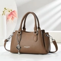 Detail of brown litchi pattern leather handbag with heart pendant and detachable strap - Coffee