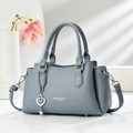 Detail of greyish-blue lychee grain leather handbag with silver heart charm and chain - Blue