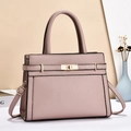 Elegant mauve lychee grain leather handbag with gold twist lock and adjustable strap - Pink