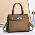 Detail of classic brown lychee texture leather handbag with elegant gold twist lock hardware - Khaki