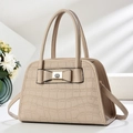 Detail of beige crocodile pattern handbag featuring a decorative bow and gold twist lock - Off White