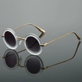Retro round sunglasses with frosted white frames and gold metal temples on reflective surface - White Frame Gray Lens