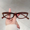 Retro dark brown oval sunglasses with slim frame for women in a minimalist street style - Tea Frame Clear Lens