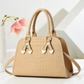Elegant khaki tote bag with crocodile pattern and golden hardware on minimalist background - Khaki