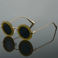 Retro round sunglasses with olive green frames and gold metal temples on black reflection - Green Frame Grey Lens
