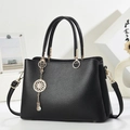 Elegant black lychee grain leather handbag with gold metal ring handles and strap - Black
