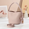 Elegant light pink pebbled leather bucket bag with top handle and gold hardware - Pink