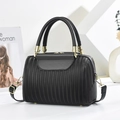 Black leather Boston bag with vertical pleated texture and gold hardware on geometric stand - Black