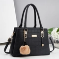 Detail of black faux crocodile leather handbag with gold hardware and plush charm - Black