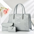 Three-piece light grey tote bag set with pleated texture and silver logo on white background - Gray